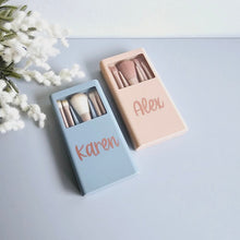 Load image into Gallery viewer, 5 blue and rose gold make up brushes sat in a personalised case with mirror inside. Personalised with a name along the front.