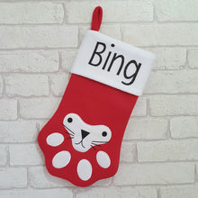 Load image into Gallery viewer, red paw shaped felt stocking with a white top. Cat face on the front of the stocking and your pets name along the top.