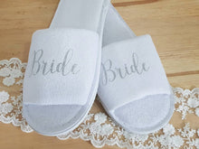 Load image into Gallery viewer, White cotton/polyester mix open toe slippers with rubber soles. Text across the middle .