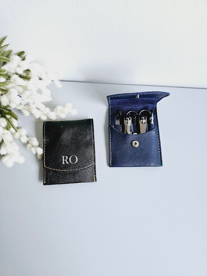 Small square faux leather case housing a 7 piece manicure set. Personalised with up to 3 initials in black or silver text. 