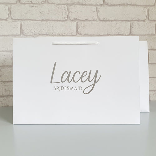 Luxury personalised white gift bag in small, medium and large sizes. Personalised with any name in gold, silver or rose gold. 