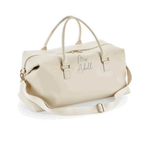 Large weekend bag made from saffino leather look fabric and high shine zips and buckles. Finished with the newly married surname of your choice. 