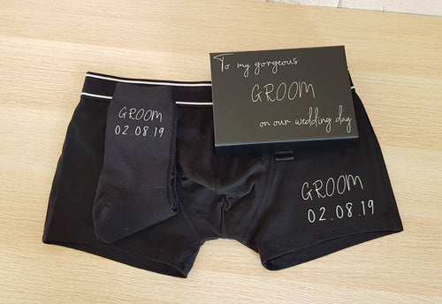 men's black cotton socks and underpants, both with groom and wedding date in silver. Complete with a black presentation box. 