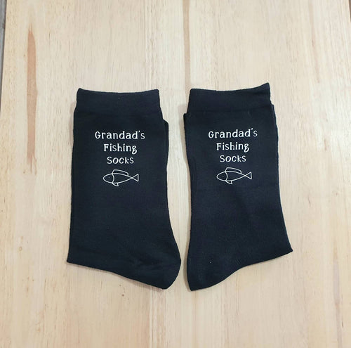 black cotton fishing socks with white text. 