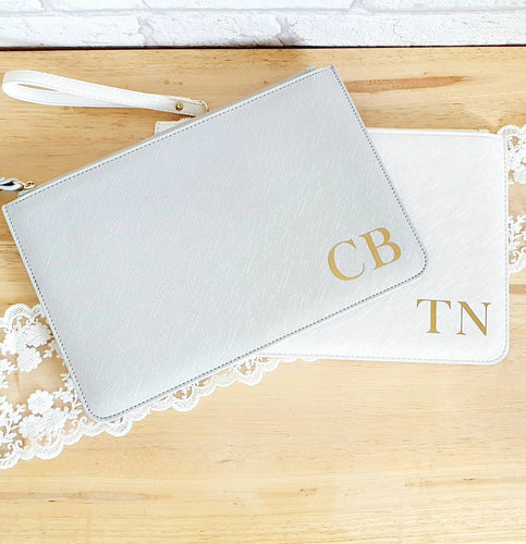 flat saffiano fabric clutch bag with wrist strap. Up to 3 initials in the bottom right corner in gold. 