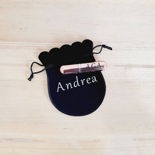 rose gold metal atomiser with up to 3 initials in black and a black velvet pouch to go with it. 