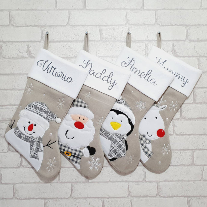 light grey Christmas stocking with a white cuff. Grey glitter name and either a snowman, Santa, penguin or reindeer.