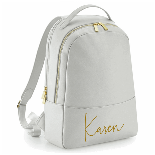 Leather look backpack in grey with gold hardwear and personalised in gold. 