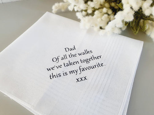 white, square, cotton handkerchief with black text on one corner. 