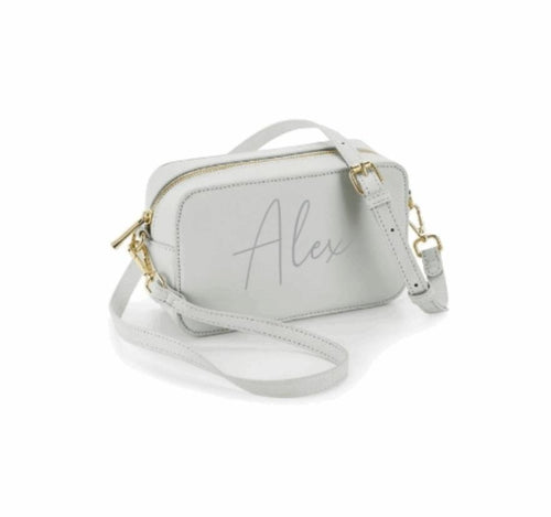 rectangular cross boy bag in grey finished with high shine gold zips and buckles. Personalised across the front.